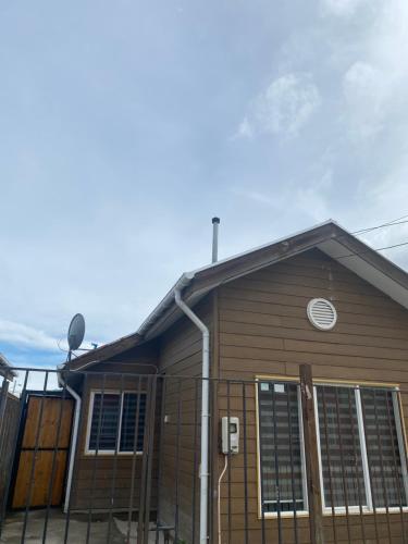 a house with a fence on the front of it at victoria in Porvenir