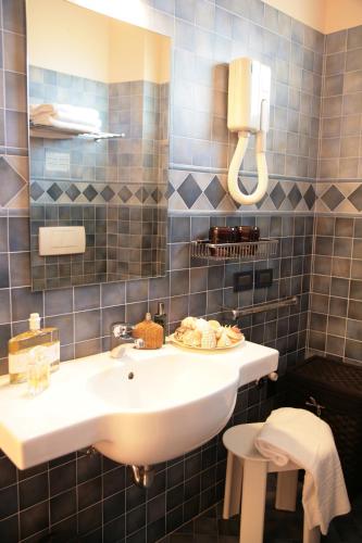 a bathroom with a sink with a plate of food on it at Residence San Paolo in Lido di Savio