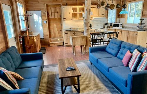 a living room with a blue couch and a table at Domaine Summum in Mont-Tremblant