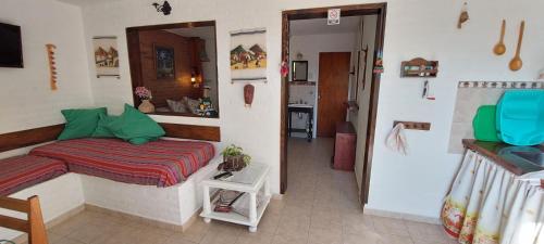 a small bedroom with a bed and a hallway at Balcon Al Paradiso in Santa Rosa de Calamuchita