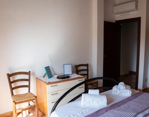 a bedroom with a bed and a desk and chairs at Residence del sole in Àrbatax