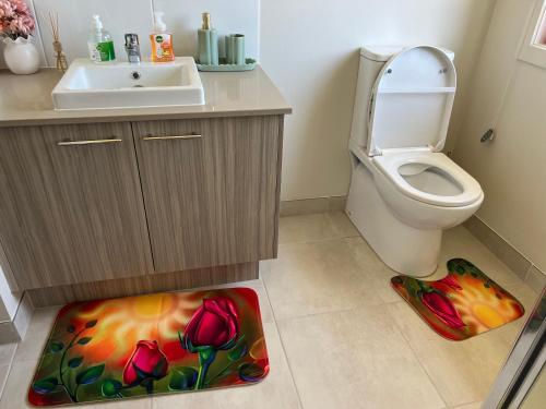 a bathroom with a toilet and a sink at Paradise pavilion hide away in Cranbourne
