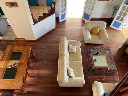 a living room with two couches and a table at BluePalm case in Petit-Bourg