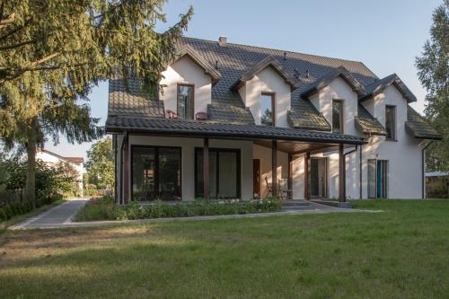 a house with a green lawn in front of it at Gościniec Szpakówka in Czeremcha
