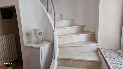 a stairway with a vase sitting on a table at CORTE RITALTONI in Passirano