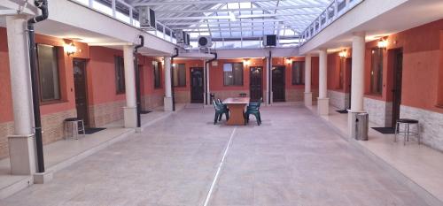 an empty hallway with chairs and a table in a building at Hotel Fantasy in Lyubimets