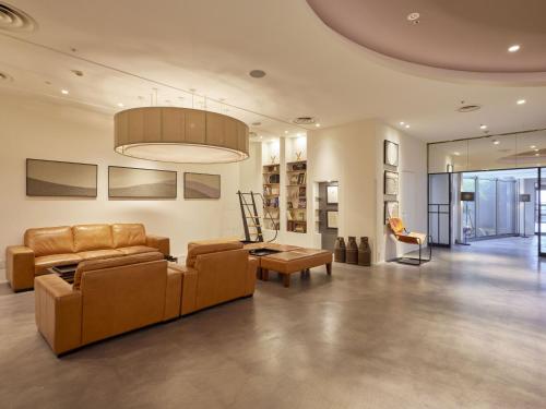 a living room with two couches and a couch and a table at Hilltop Resort Fukuoka in Fukuoka