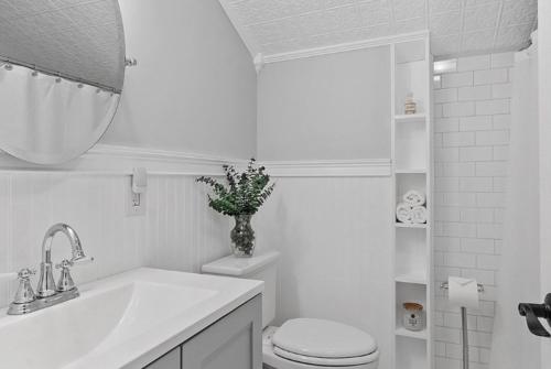 a white bathroom with a toilet and a sink at Private Bedroom in a Single House at Framingham center in Cranston