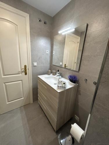 een badkamer met een wastafel en een spiegel bij JARDINES DEL MAR - Benalmadena Costa in Benalmádena