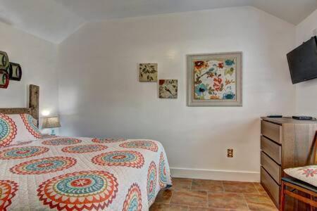 a bedroom with a bed and a dresser and a tv at Spanish Village Siesta Villa in Port Aransas