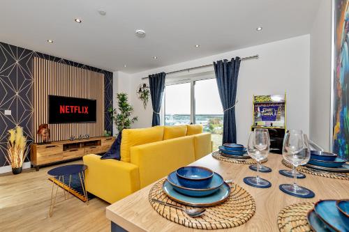 a living room with a yellow couch and a table at Luxury Apartment-Free Parking-Central Location-Close To Airport, Station & Centre in Luton