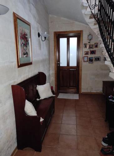 a living room with a couch and a staircase at One Lemon Tree apartment (1.6 km from Airport) in Luqa