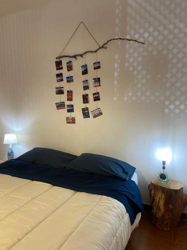 a bedroom with a bed with a bunch of pictures on the wall at Appartamento Homemade in Biella