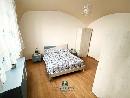a bedroom with a bed in a room at O' MAR FOR casa vacanza in Bacoli