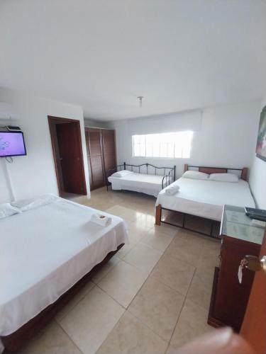 Postel nebo postele na pokoji v ubytování Hotel Sierra Nevada B&B SAS
