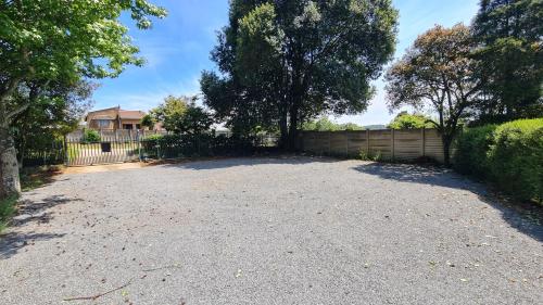 a driveway in front of a house with a fence at The Puffin's Nest in Hilton