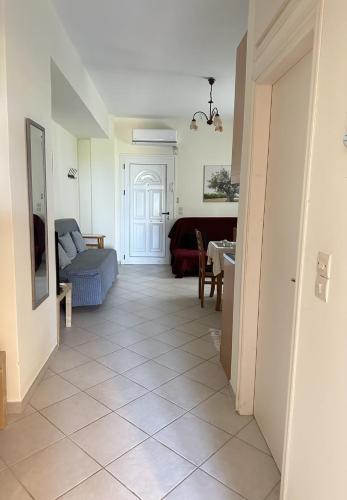a living room with a couch and a table at Casa Blanca (I) in Pyrgos Dirou