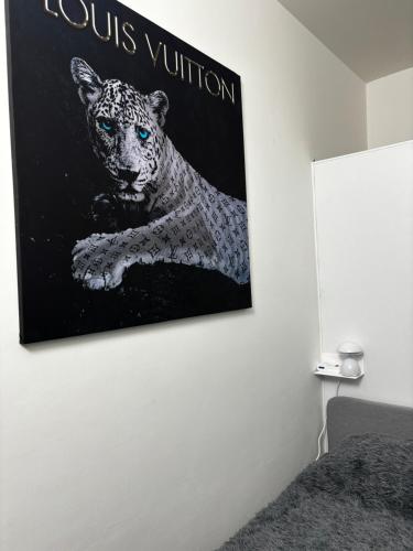 a picture of a jaguar on a wall at Villa Life in San Donato Milanese
