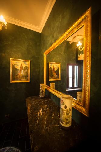 a bathroom with a large mirror and a counter at Borgo Boutique Home near Rome in Nettuno