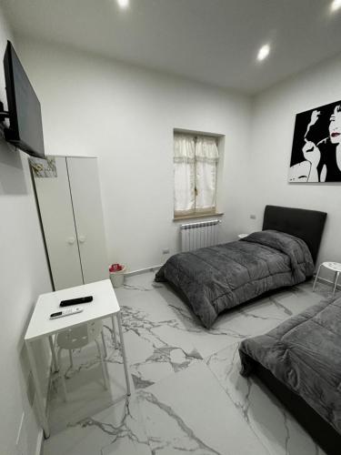 a bedroom with a bed and a desk and a table at Villa Life in San Donato Milanese