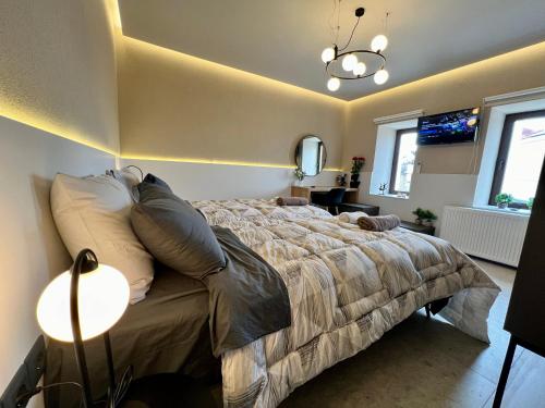 a bedroom with a large bed and a lamp at Suite Rooms - Fine Living in Vévi