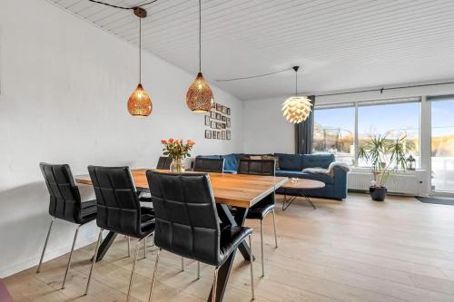 a dining room and living room with a table and chairs at Nice and Cozy family house at Billund Center in Billund