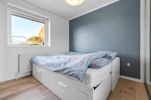 a bedroom with a bed with a window at Nice and Cozy family house at Billund Center in Billund