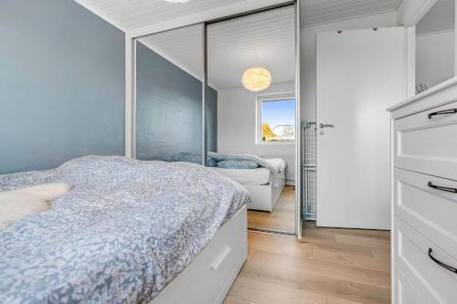 a bedroom with a bed and a mirror at Nice and Cozy family house at Billund Center in Billund