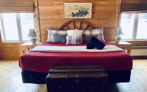 a bedroom with a large bed with a wooden wall at Domaine Summum in Mont-Tremblant