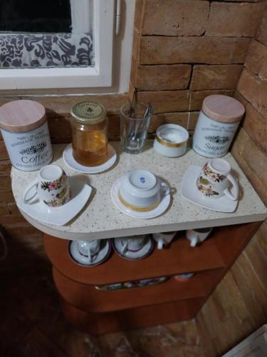 a table with tea cups and saucers on it at HARMÓNIA HÁZ in Makó
