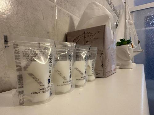 a counter with three cups of milk and a box at [2 passi dal mare di Alassio] Ampio trilocale in Alassio