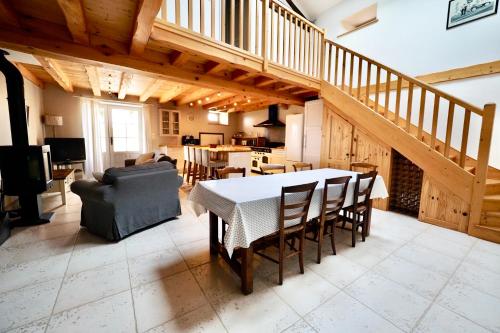 a kitchen and dining room with a table and chairs at Logis du paradis in Criteuil-la-Magdeleine