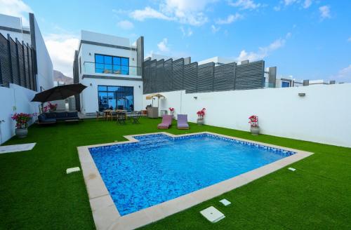 a house with a swimming pool in the yard at Al Bandar Luxury Villa with 5BHK with private pool in Fujairah