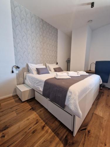 a bedroom with a large bed with white sheets at Apartment Anya in Koper