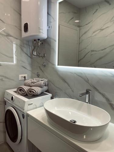 a bathroom with a washing machine and a sink at Apartment Lantana Hvar in Hvar