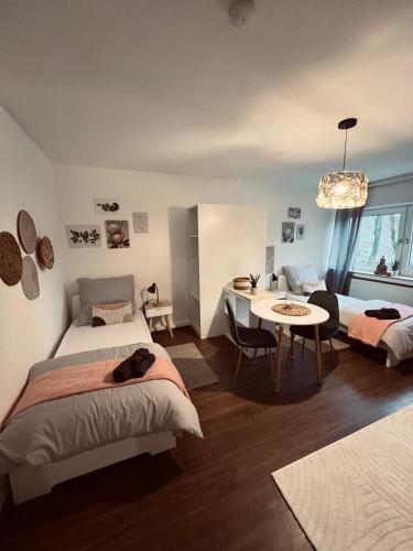 a bedroom with two beds and a table and a dining room at Große Apartments für Monteure & Feriengäste in Dorsten