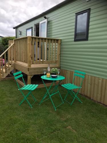 a table and chairs in front of a house at Georgia Lodge in Knaresborough