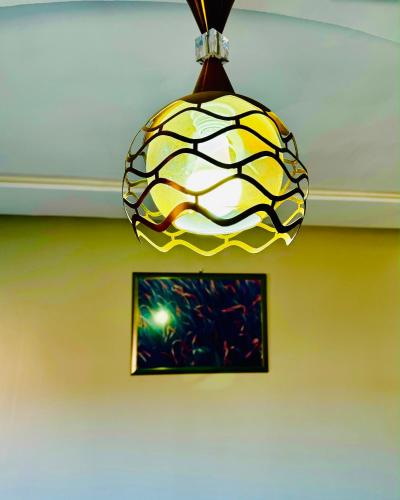 a yellow and white pendant light hanging from a ceiling at COMPLEXE L'OASIS in Erfoud