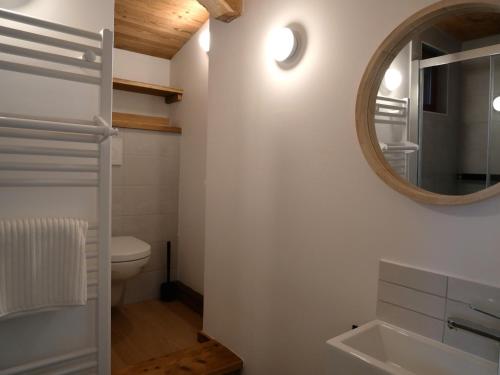 a bathroom with a toilet and a mirror at La ferme d'Hauteluce - Chalets in Hauteluce