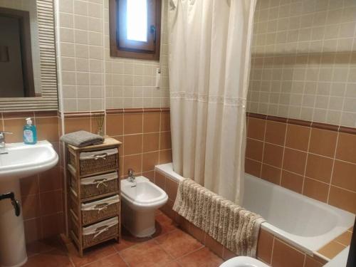a bathroom with a sink and a toilet and a shower at Apartamento Gandía, Orihuela del Tremedal. in Orihuela del Tremedal
