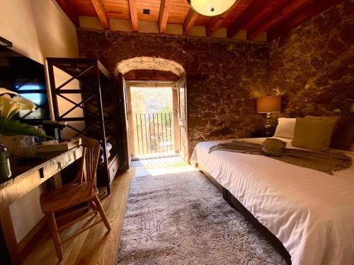 a bedroom with a bed in a room with a window at HOTEL MINA REAL in Real de Catorce