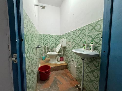 a bathroom with a toilet and a sink at Nest Tales Backpacker Hostel in Khajurāho