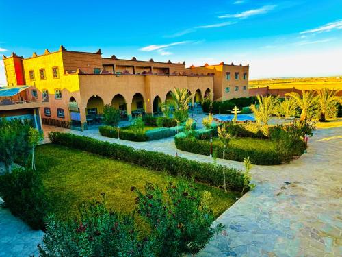 a view of a building with a garden in front at COMPLEXE L'OASIS in Erfoud