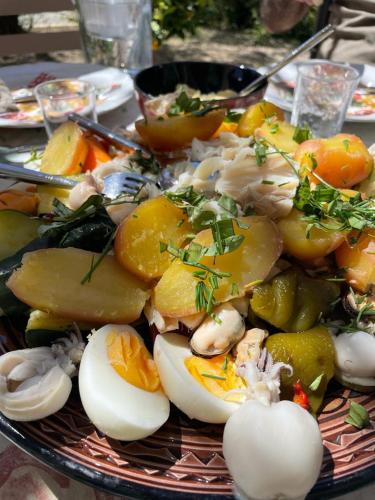 a plate of food with eggs and fruit on a table at Gîte Mas des ricochets in Aigremont