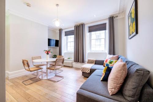 a living room with a couch and a table at Welcome London St Martin's in London