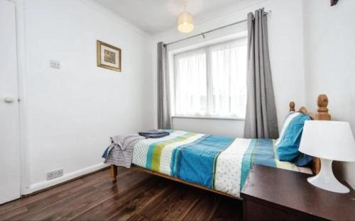a bedroom with a bed and a window at Lovely 2 bedroom flat in Luton no kitchen facilities free parking in Luton