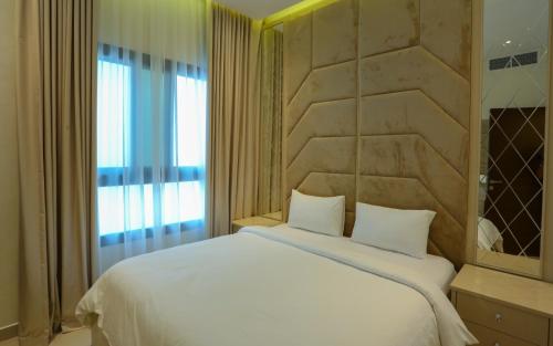 a bedroom with a large white bed and a window at Luxury Villa 5 bedrooms with sea view and free boat in Fujairah