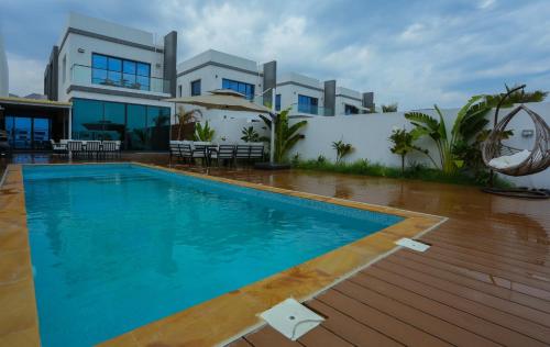 a swimming pool in front of a house at Luxury Villa 5 bedrooms with sea view and free boat in Fujairah