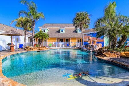 a large swimming pool in front of a house at Crane's Landing at Pirates Bay in Port Aransas