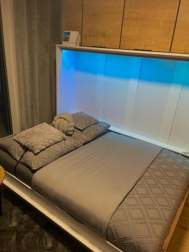 a bed in a room with a glass wall at Apartmán pod Tatrami in Poprad